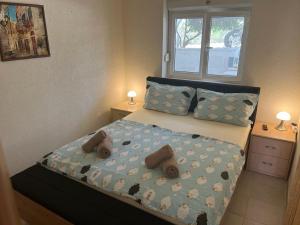 a bedroom with a bed with stuffed animals on it at Villa West Point in Okrug Donji