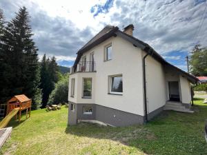 ein Haus in einem Hof mit Spielplatz in der Unterkunft Apartmány Josefáč se saunou, zahradou a dětským hřištěm in Josefův Důl u Jablonce nad Nisou