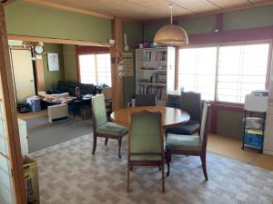 a living room with a dining room table and chairs at 余呉の里山-ランプの宿-さくら in Nagahama