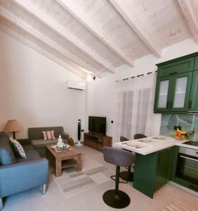 a living room with a couch and a table at The Old Stables Apartment in Vátos