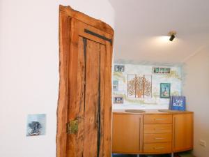 an open wooden door in a room with a dresser at PaKua apartments & Penthouse with 2 terraces in Rovinj