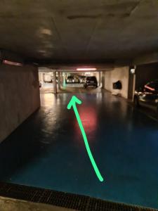 zielona strzała na podłodze garażu w obiekcie Superbe Appartement 3 pièces près de la Défense w mieście Nanterre