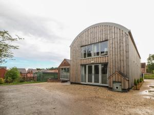 a barn style building with a large window at The Haybarn in Lichfield