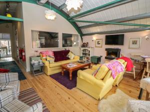 a living room with two couches and a table at The Haybarn in Lichfield