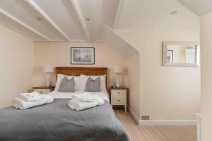 a bedroom with a bed with two towels on it at Room 5, Hotel style Double bedroom in Marazion in Marazion