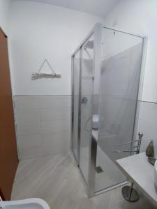 a shower with a glass door in a bathroom at Villa Wunjo IUN R3267 in La Maddalena
