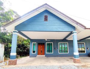 a blue house with a red door at DLuna Homestay Terengganu in Kuala Terengganu