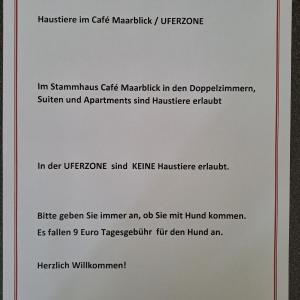 een getypt document bovenop een wit papier bij Hotel-Ferienwohnungen Cafe Maarblick in Schalkenmehren