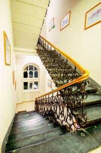 a spiral staircase in a building with green steps at CityNest Apartments in Krakow