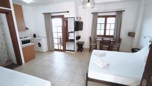 a large room with a kitchen and a living room at Dedalos n3 Sea View apartment-30 metres from the beach in Stalís
