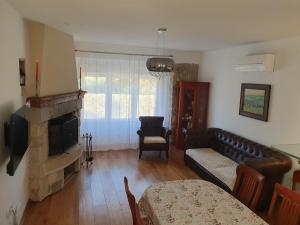 a living room with a couch and a fireplace at Apartment NINA in Rab