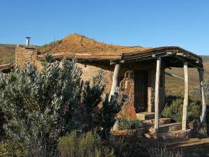 a small stone house with a roof at Rangers Reserve in Touwsrivier