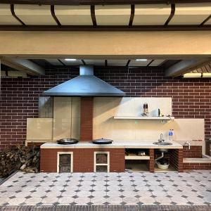 a kitchen with a stove top oven in a building at Zima-Leto in G‘azalkent