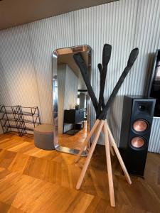 a mirror and two wooden sticks on the floor in a room at Štýlový loft s ohromnou terasou in Bratislava