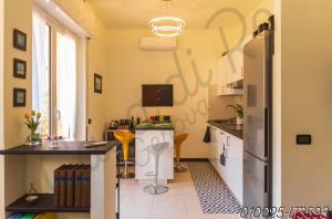 a kitchen with a refrigerator and a counter top at Casa di Ro - New Foce in Genoa