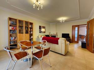 a living room with a table and chairs and a couch at Vila Limoeiro in Salir de Porto