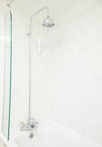 baño con ducha y puerta de cristal en Cock Hotel by Greene King Inns en Stony Stratford