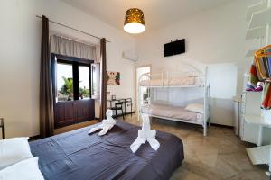 een slaapkamer met een bed met witte handdoeken bij B&B Kòre in Castellammare del Golfo
