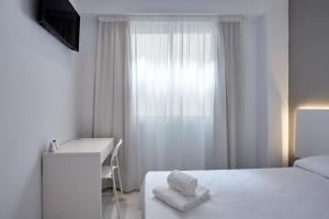 Postel nebo postele na pokoji v ubytování Hotel DL Port