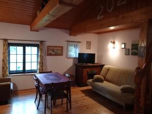 a living room with a couch and a table at Agroturystyka Oczko in Ogonki