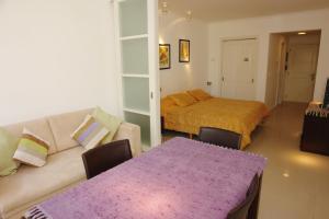 a living room with a couch and a bed at Green Park en Punta del Este in Punta del Este +71 photos