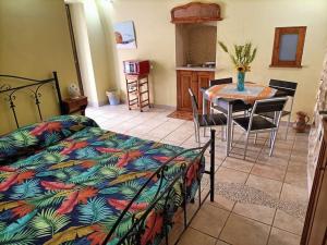 a bedroom with a bed and a table with chairs at Il nido delle aquile in Oria