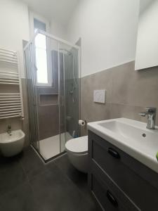 a bathroom with a shower and a toilet and a sink at Parea House 3 in Milan