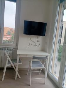 a white desk with a television on top of it at Parea House 3 in Milan