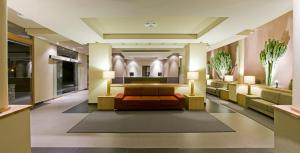 a lobby of a hotel with a couch and tables at Hotel Playa Calera in Valle Gran Rey