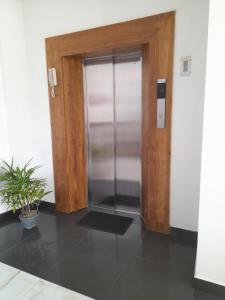 a glass door in a room with a potted plant at Marine Tourist Guest House at Negombo Beach in Negombo