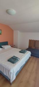 a bedroom with a bed with two towels on it at Apartments Provence in Sozopol