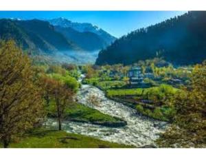 a river in the middle of a valley with trees at Blue heaven House boat, Srinagar in Srinagar