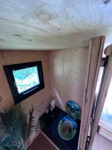 a small room with a tv on the wall at Hop and hare farm in Hastings