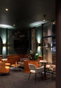 a lobby with chairs and tables and a couch at Hotel Nova in Berlin