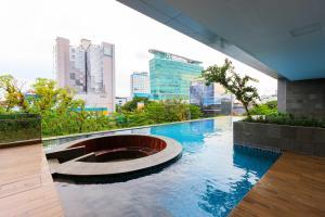 a swimming pool in the middle of a city at Calma 31 Apartment in Makassar