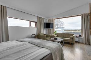Postel nebo postele na pokoji v ubytování Eyvindarholt Guesthouse
