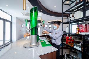 a man with a face mask standing at a bar at Havana Hotel Mandalay in Mandalay