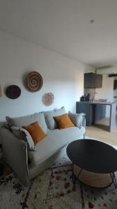 a living room with a couch and a table at Mini maison au coeur de la Loire in Amboise +11 photos