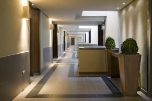 a hallway of a hospital with potted plants at Hotel Playa Calera in Valle Gran Rey
