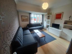 a living room with a couch and a table at APARTAMENTO VIGO CAMELIAS CENTRO in Vigo