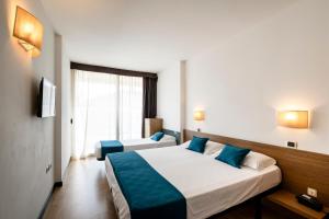 Postel nebo postele na pokoji v ubytování Hotel Cristallo