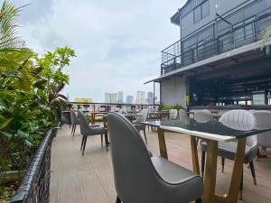 a patio with tables and chairs on a building at CHECK inn Phnom Penh BKK1 in Phnom Penh