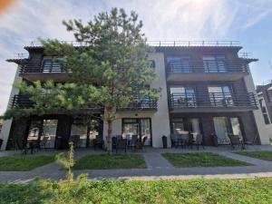 a building with tables and chairs in front of it at 4rest in Palanga