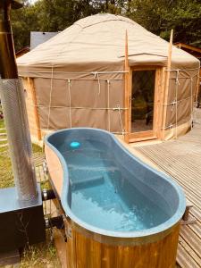 a hot tub in front of a yurt at Yourte et son bain nordique in Fréchet-Aure