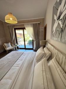 a large white bed in a room with a window at Alicra Hotel Çıralı in Cıralı