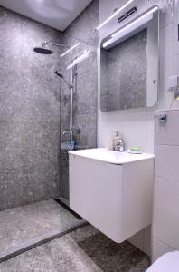 a bathroom with a white sink and a shower at Anel apartment in St. St. Constantine and Helena