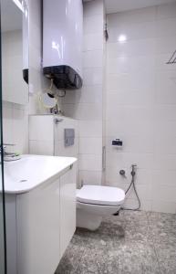 Baño blanco con aseo y lavamanos en Anel apartment en Saints Constantine and Helena