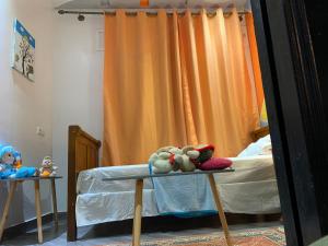 two stuffed animals sitting on a table in a bedroom at Appartement familiale Amjad 3 chambres in Tangier