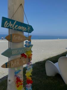 um sinal que diz bem-vindo à praia e ao bar em “Temesa House” il mare a due passi da te! em Campora San Giovanni