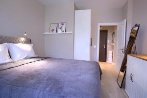 um quarto com uma cama grande e um cobertor azul em Anel apartment em St. Constantine and Helena